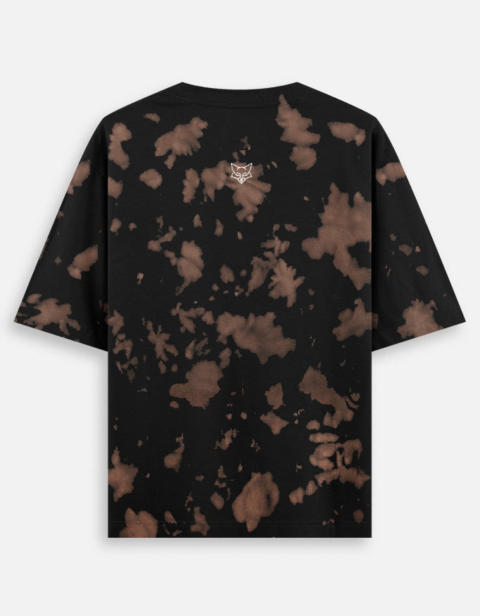 Black short sleeve t-shirt with brown bleach splatter pattern and small fox logo on the back
