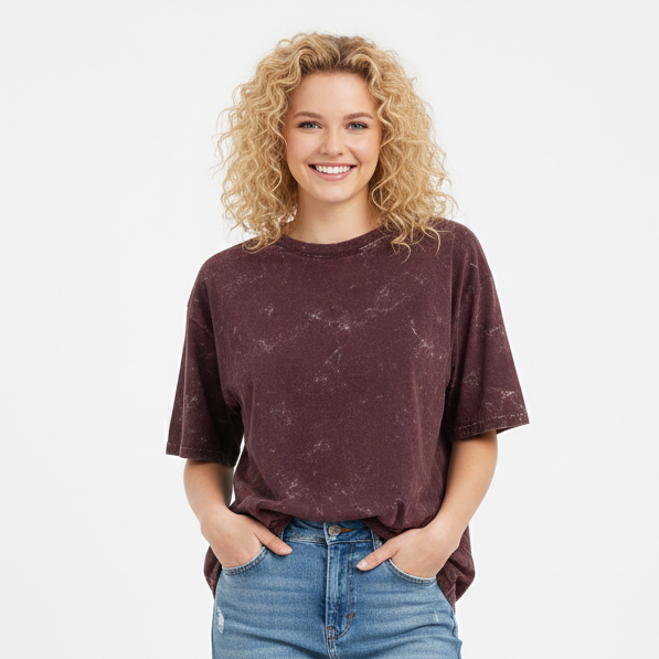 Woman wearing a maroon t-shirt and light blue jeans on a white background