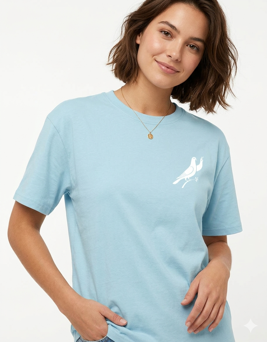 Woman wearing light blue t-shirt with white dove graphic on chest, casual style