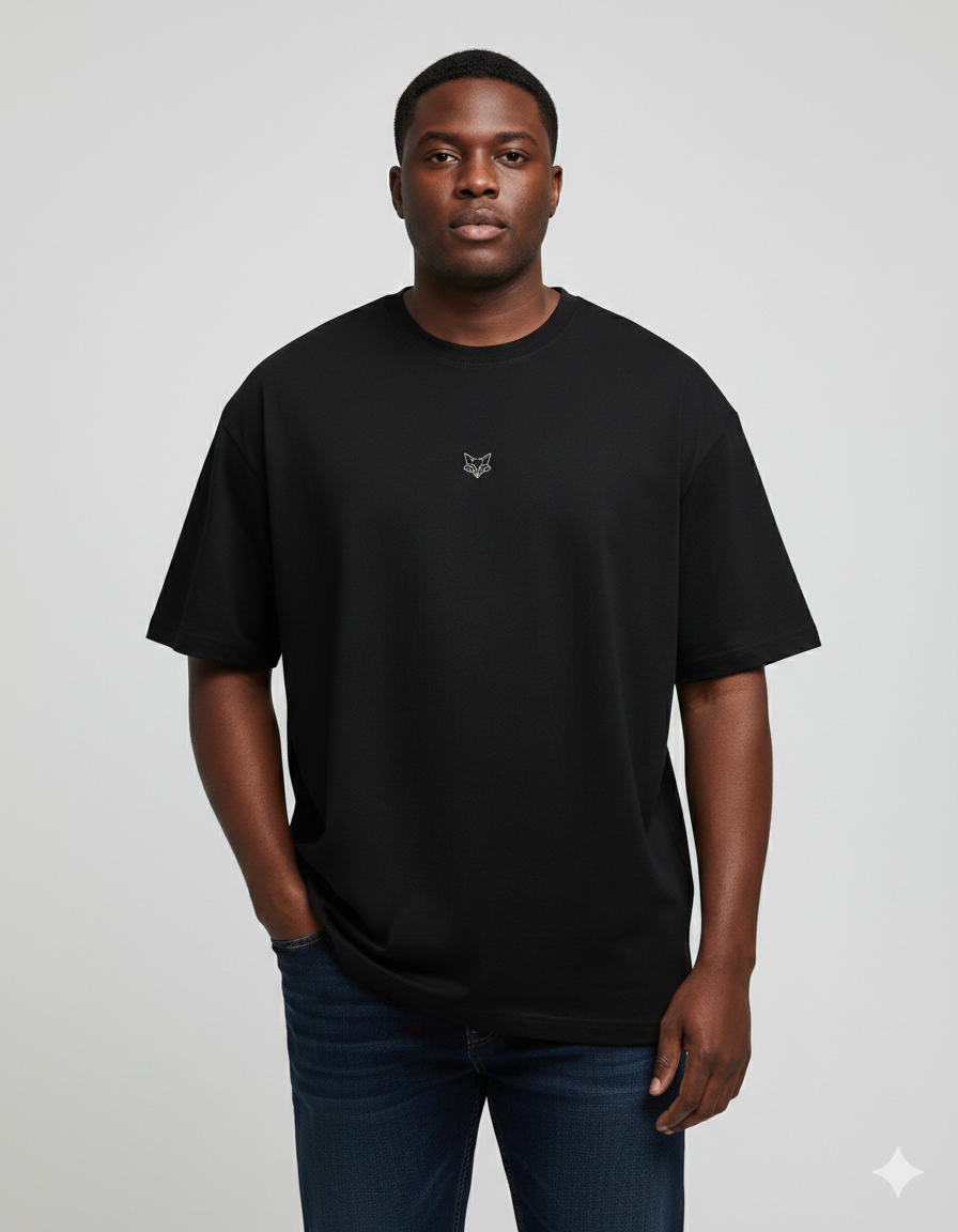 Man wearing a black t-shirt with a small logo on a plain background - Tinyfox