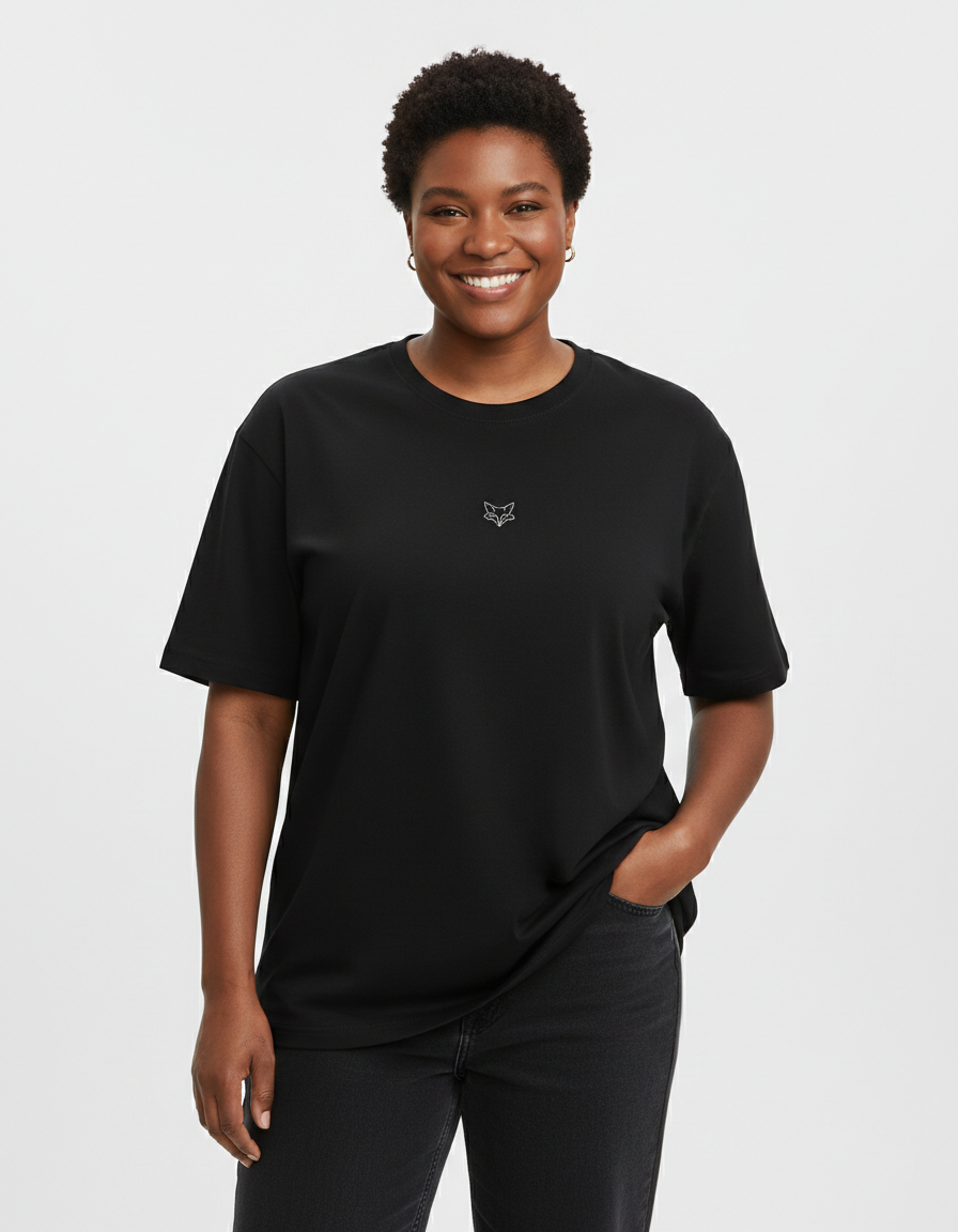 Person wearing a black t-shirt with a small TinyFox logo on a white background