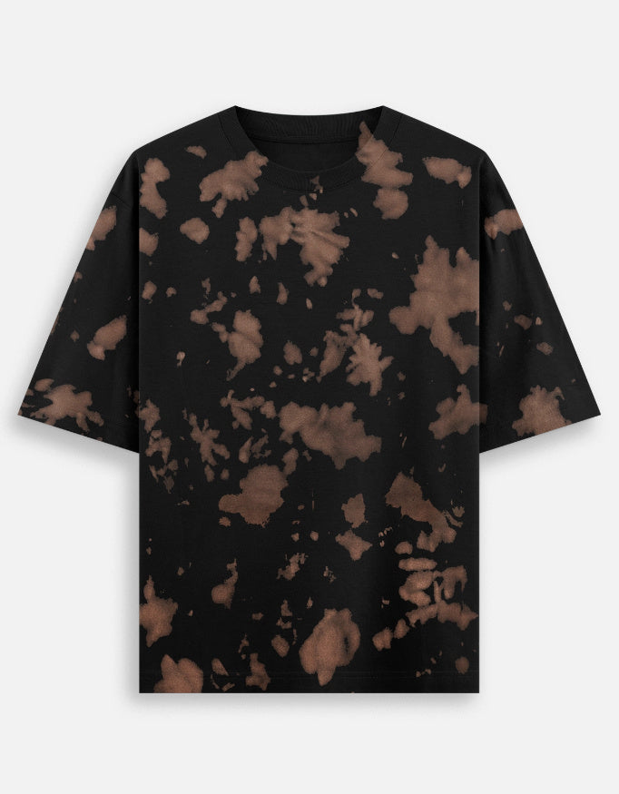Black t-shirt with brown bleach splatter pattern, short sleeves, flat lay on white background