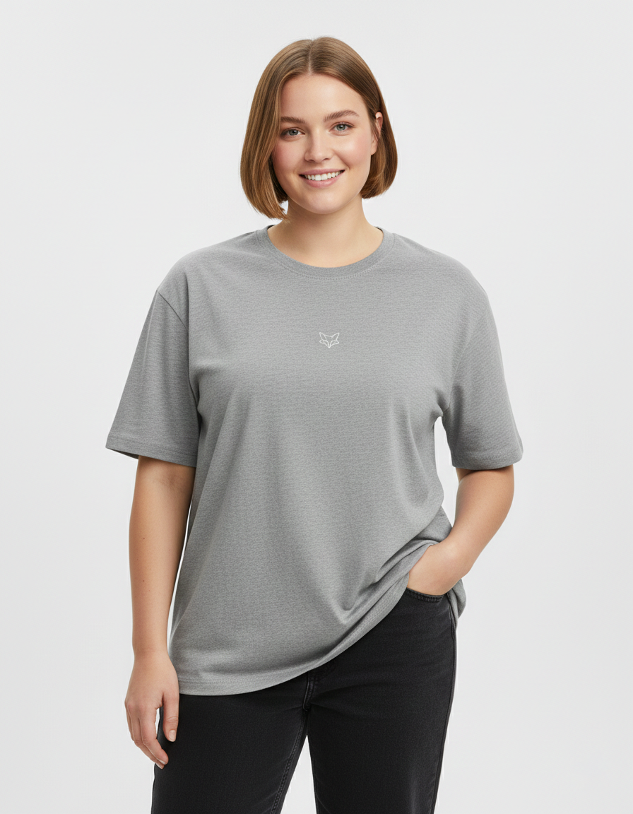 Woman wearing a gray t-shirt with a small TinyFox logo on a white background