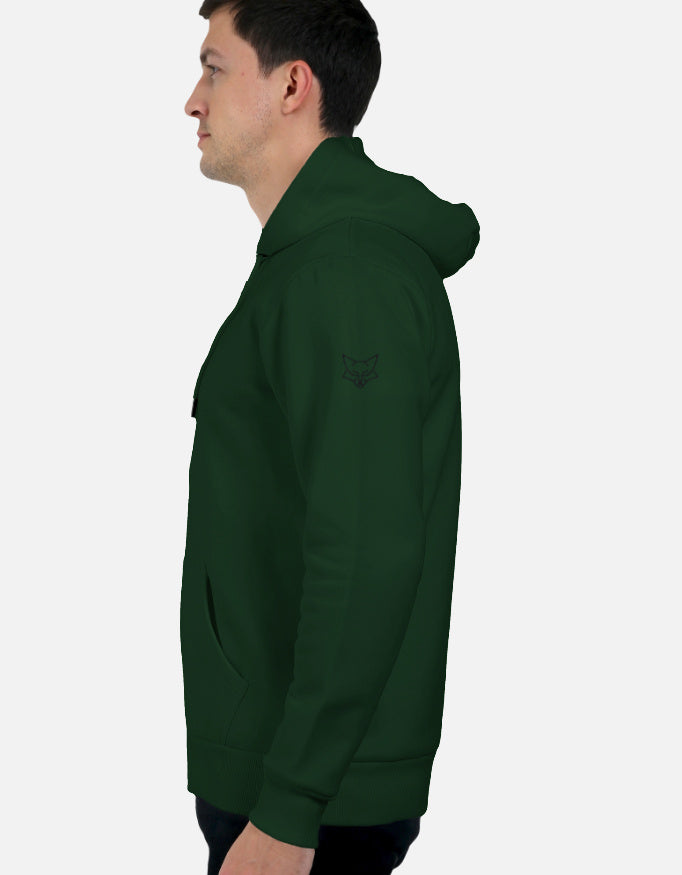 Man wearing dark green hoodie with fox logo on left shoulder, side profile view