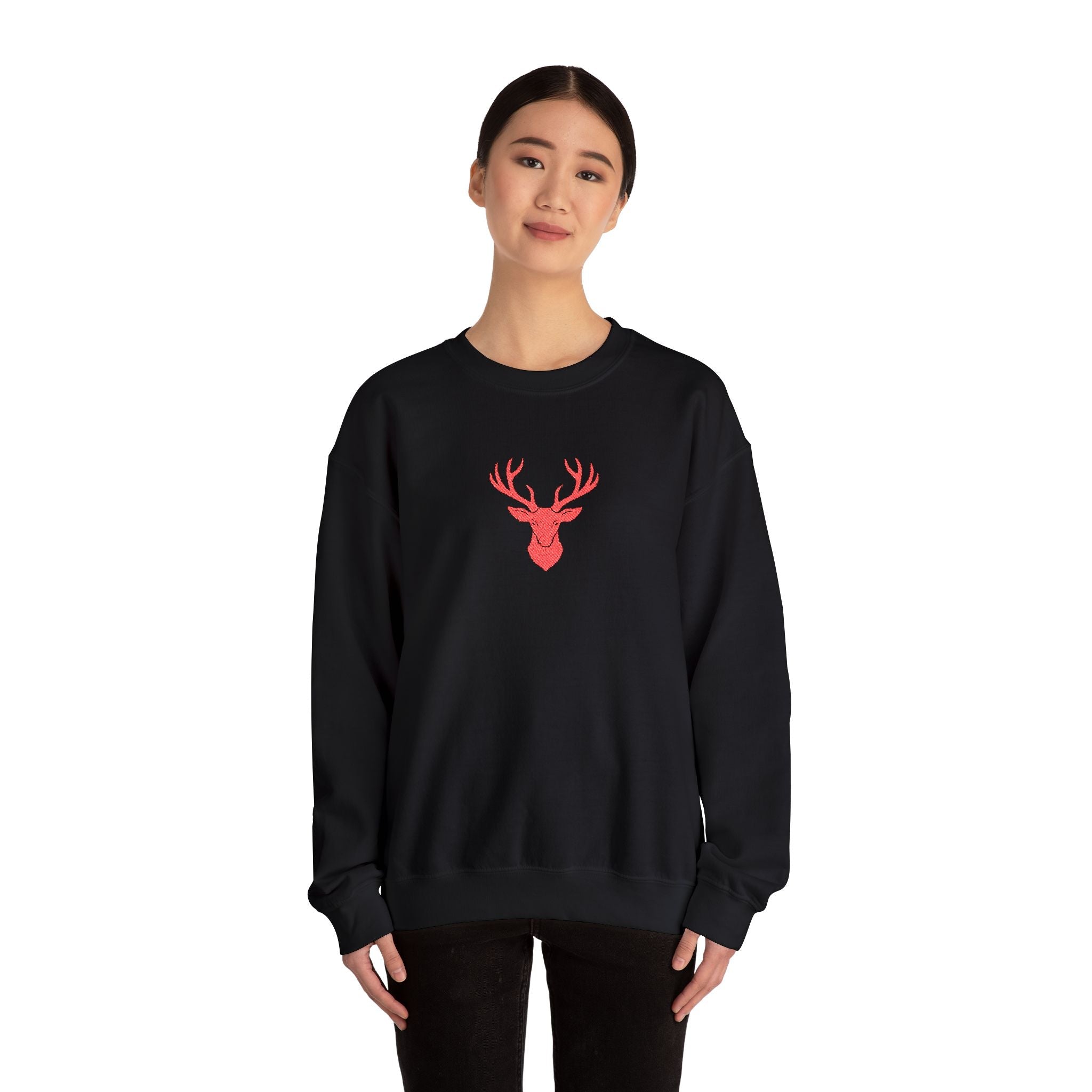 Person wearing a black sweatshirt with a red deer design on a white background