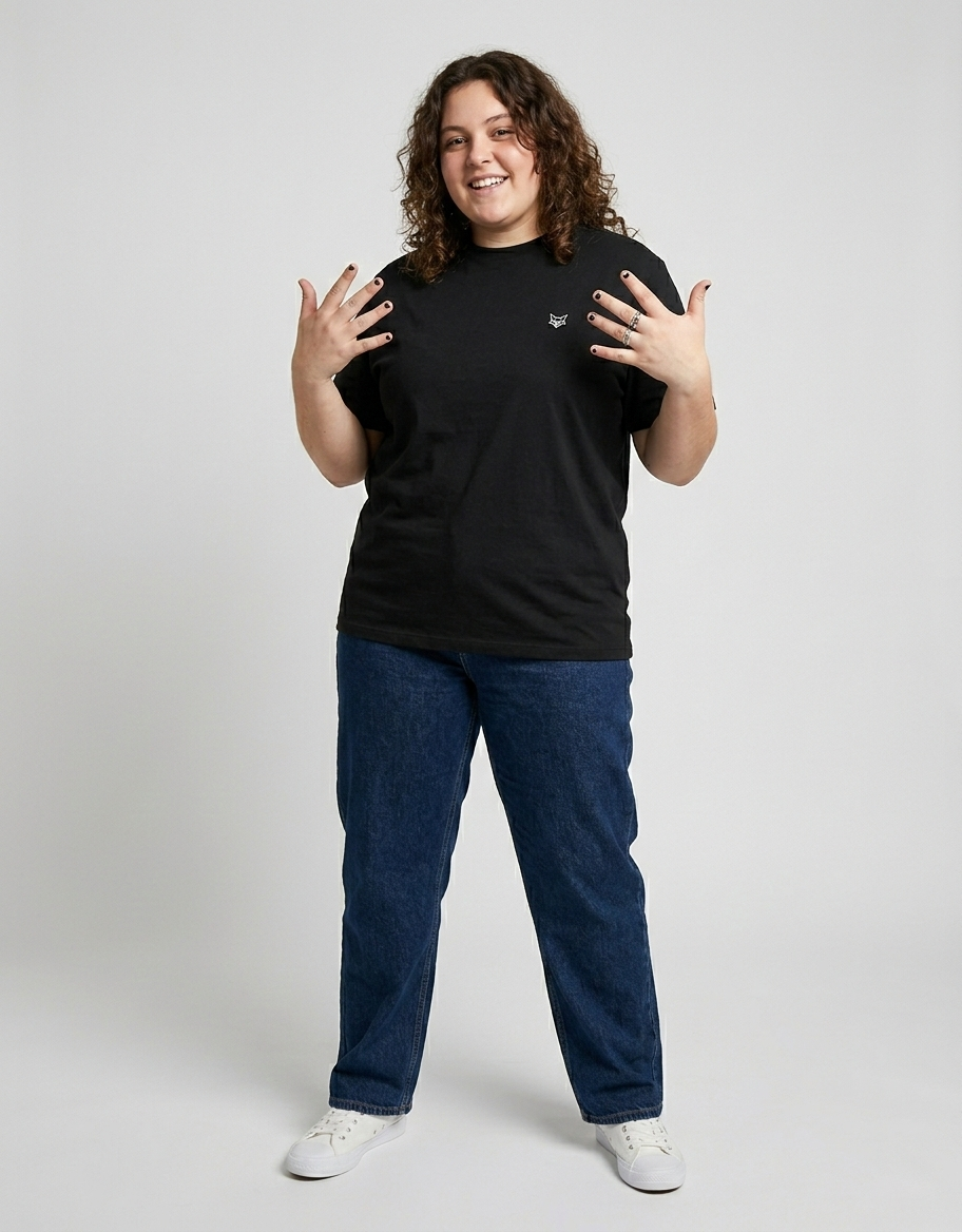 Plus size person wearing casual black t-shirt, blue jeans, and white sneakers