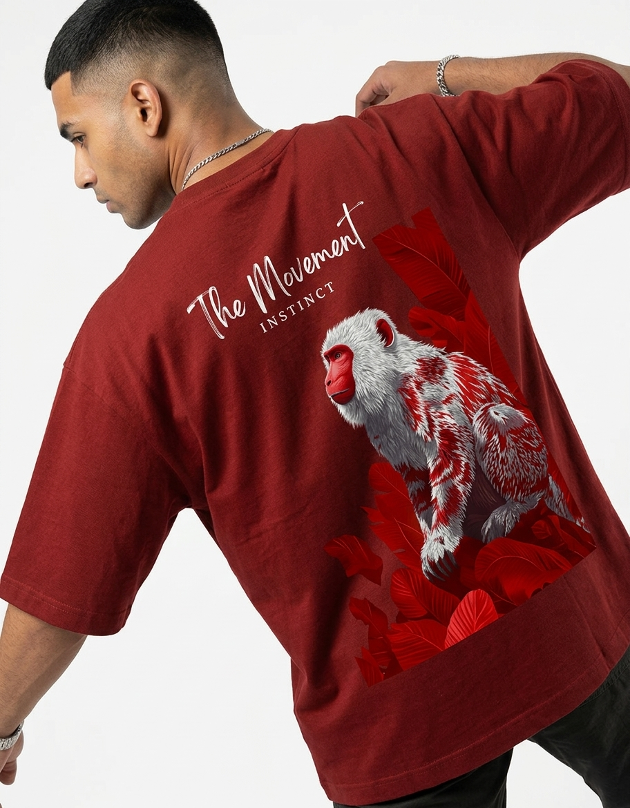 Man wearing a red T-shirt with white and red monkey graphic and 'The Movement Instinct' text